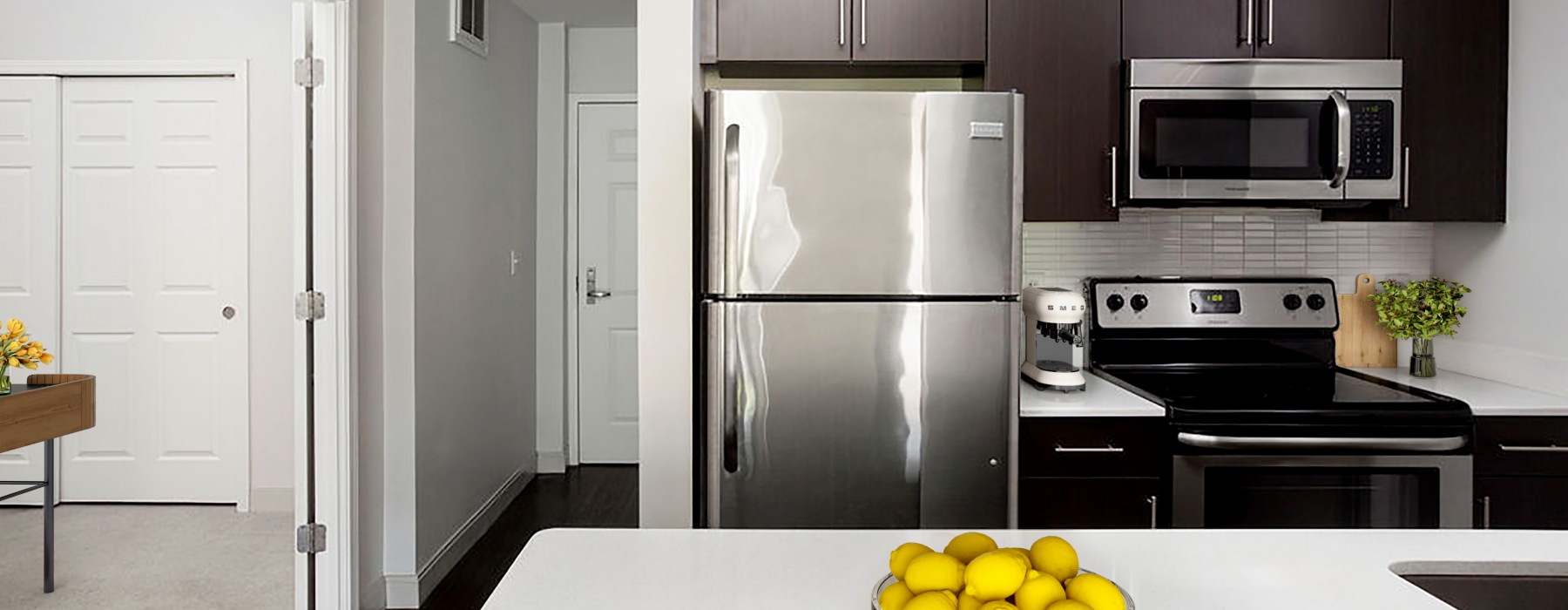 Luxury kitchen featuring stainless steel appliances, quartzkitchen island, and modern finishes 